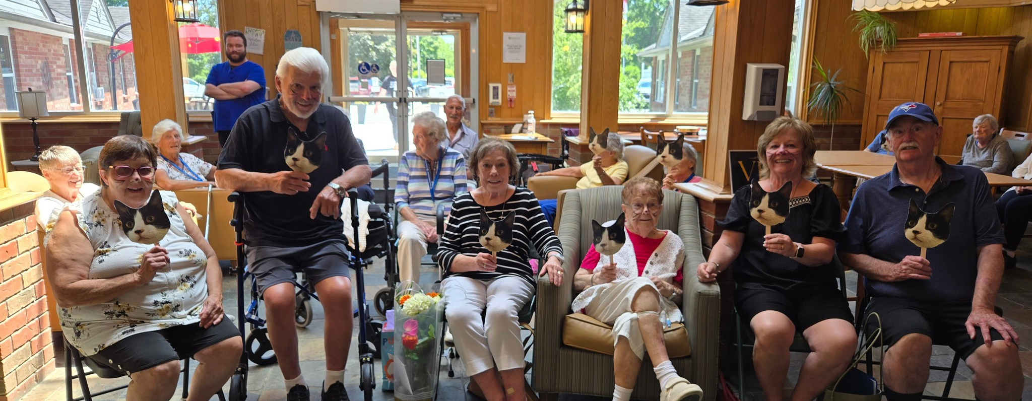A group of residents gathering in the bright Atrium