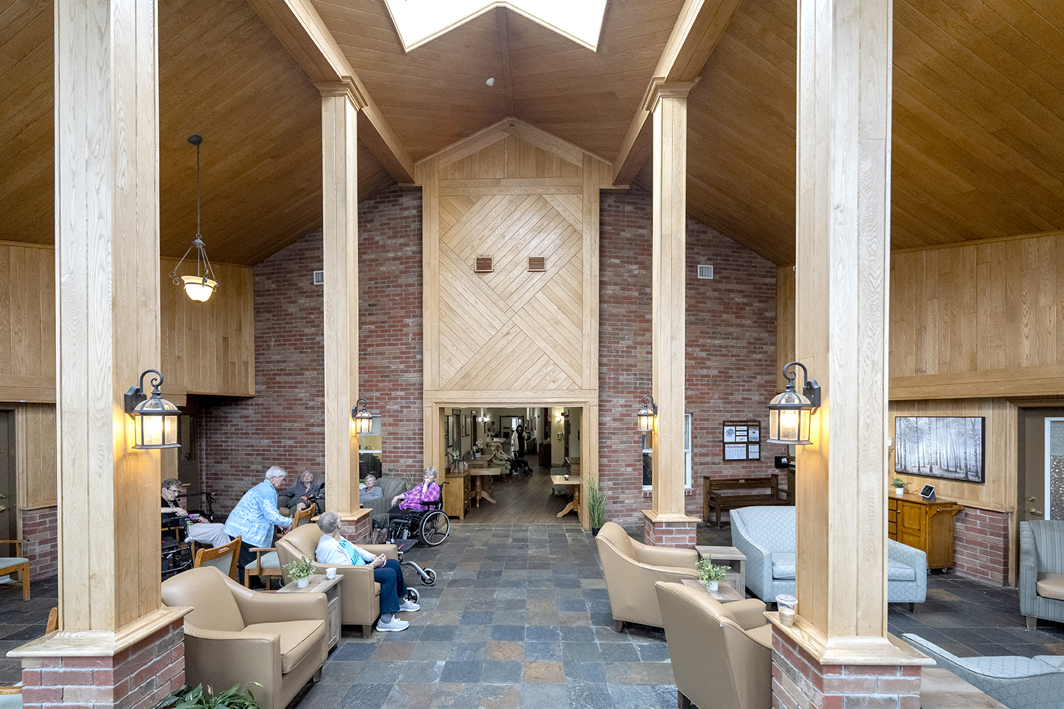 Residents enjoying the bright, spacious atrium at Atrium Retirement Residence in Orillia.
